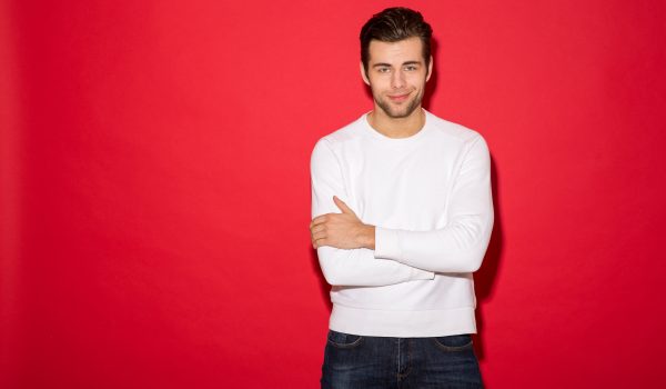 cool smiling man in sweater looking at the camera