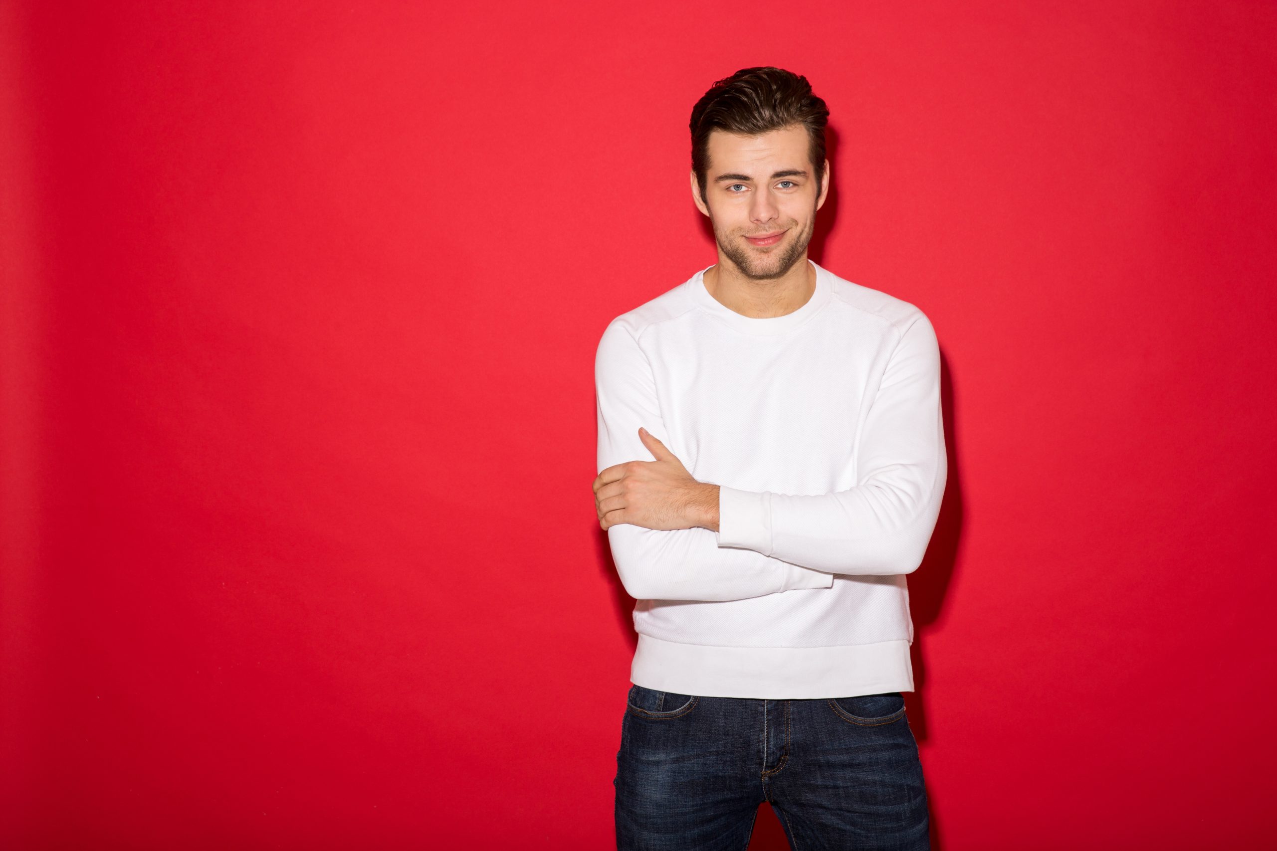 cool smiling man in sweater looking at the camera